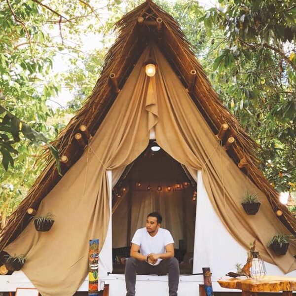 mid-adult-man-sitting-entrance-glamping